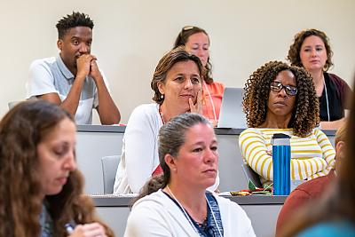 A group of Summer Institute audience members listening to a presentation