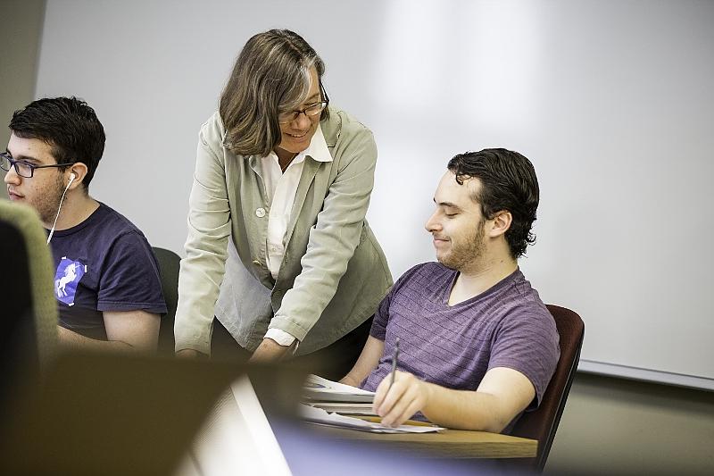 professor consulting with student during class