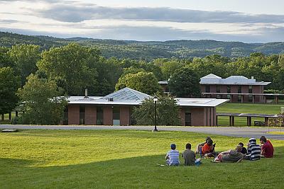 Landmark College students sitting on the upper campus green during the summer.