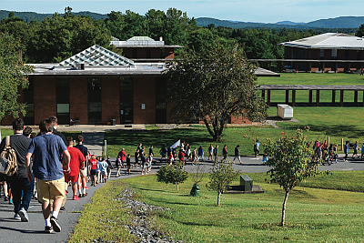 View of L和mark College upper campus with student traveling down the hill in a line. 