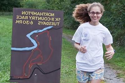 Landmark College student running cross country on trail